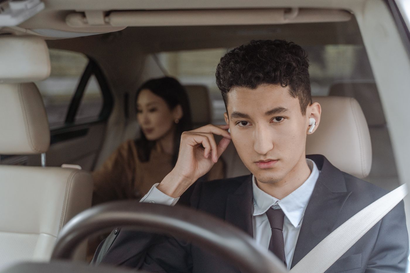 Chauffeur driving passengers in a private vehicle